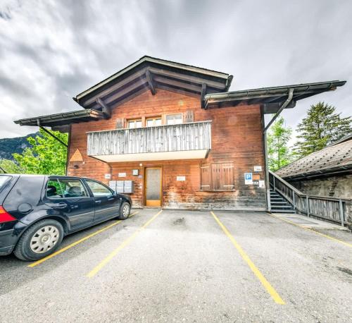 a car parked in a parking lot in front of a building at Apartment Eiger - Aare Jungfrau AG in Grindelwald