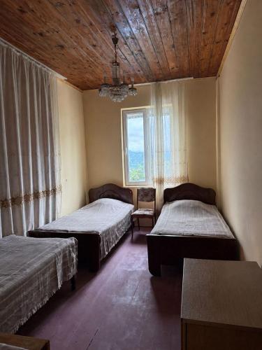 a room with two beds and a window at Tsikhisdziri Hotel in Ts'ikhisdziri