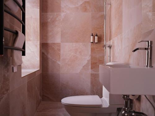 a bathroom with a toilet and a sink at Hotell Visby Börs in Visby