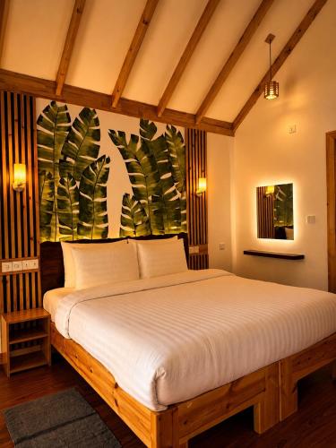 a bedroom with a large bed in a room at Black Pearl View in Himandhoo 
