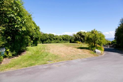an empty road with trees on the side of it at The Point Villas in Taupo
