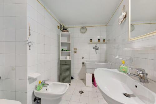 a white bathroom with a sink and a toilet at Casa Regina Salò in Salò