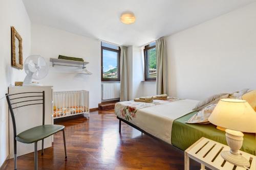a bedroom with a bed and a table and a chair at Casa Regina Salò in Salò