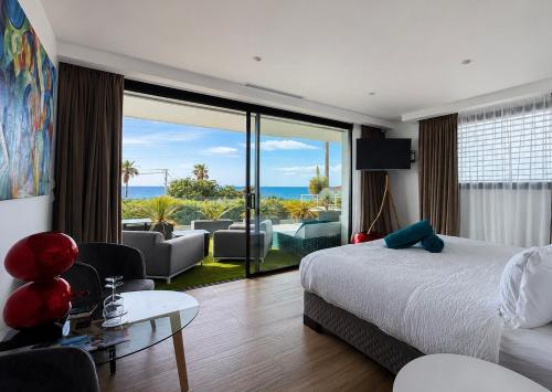 a bedroom with a bed and a view of the ocean at VILLA MIAMI in Les Issambres