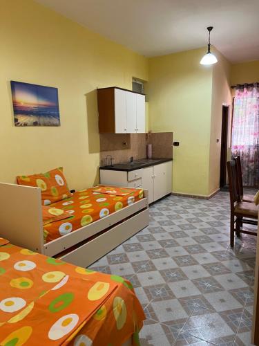 a large room with two beds and a kitchen at Velipoja Hospitality in Velipojë