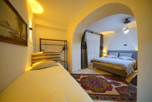 a hotel room with two beds and a window at Diamond Village Ortahisar in Ürgüp