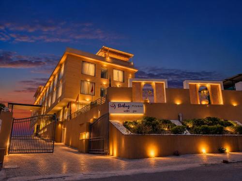 a building with a sign in front of it at night at Sterling Pushkar in Pushkar