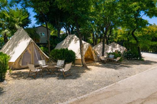 a group of tents with chairs and a table at Kampaoh Estepona in Estepona