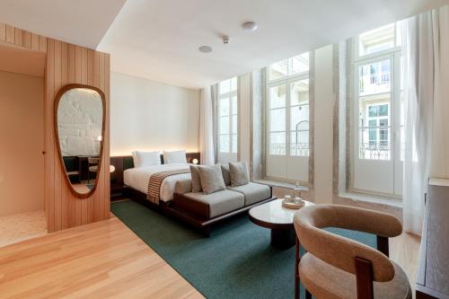 a hotel room with a bed and a mirror at NOLIA Boutique Hotel in Porto