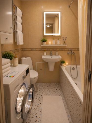 a bathroom with a washing machine and a sink at Luxury 3 Rooms Apartments in Center by Green House in Poltava