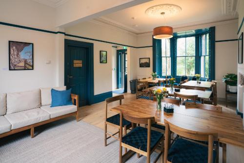 a living room with a table and a couch at Base Camp Hathersage, YHA Partner in Hathersage