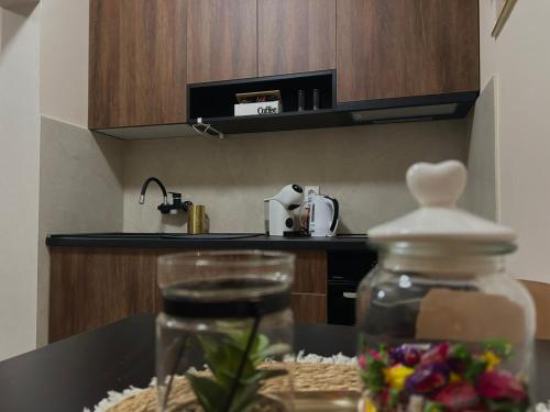 a glass jar on a table in a kitchen at Apartman Aleksandra 2 in Bečej