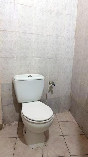 a bathroom with a white toilet in a stall at lala salama in Zanzibar City