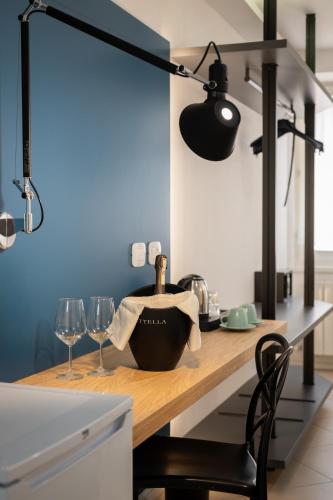 a kitchen with a table with glasses and a lamp at Hotel Lago Di Garda in Malcesine