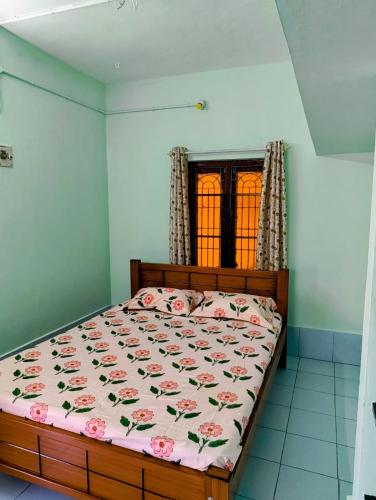 a bedroom with a bed with flowers on it at KHS Ranganath-U in Tiruchirappalli