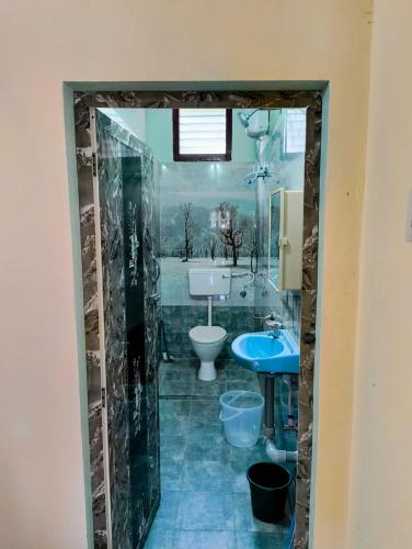 a bathroom with a toilet and a sink at KHS Ranganath-U in Tiruchirappalli