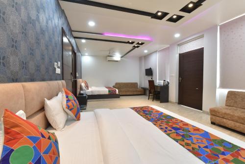 a bedroom with a large bed and a living room at Hotel Pearl Heritage in Jaipur