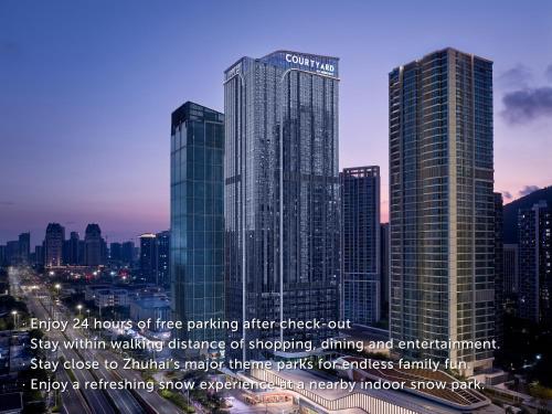 a group of tall buildings in a city at Courtyard by Marriott Zhuhai in Zhuhai