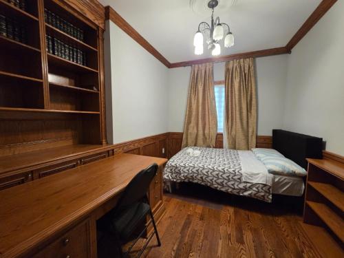 a bedroom with a desk and a bed in a room at Executive Room in North York Centre in Toronto