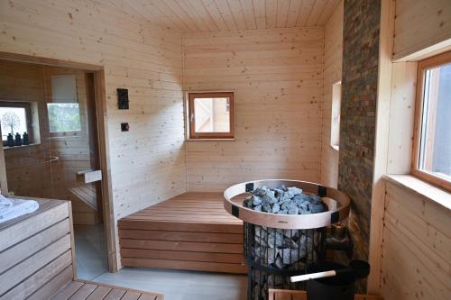 a sauna with a tub in a wooden cabin at Grajski oddih in Cerklje na Gorenjskem