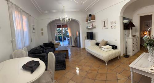 a living room with a couch and a table at VILLA CLARA ISCHIA piscina riscaldata e idromassaggio in Lacco Ameno
