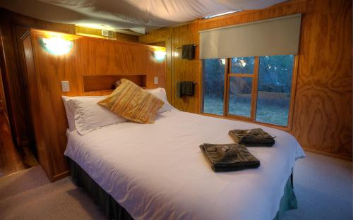 a bedroom with a bed with two towels on it at Severn-dipity in Ballandean