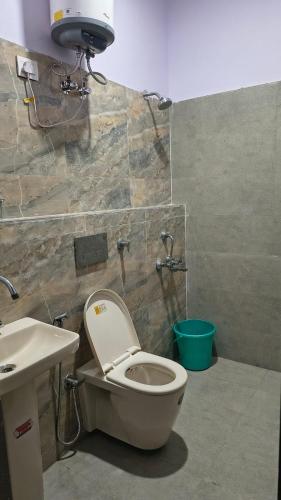 a bathroom with a toilet and a sink at YU Turn Celebrations in Greater Noida