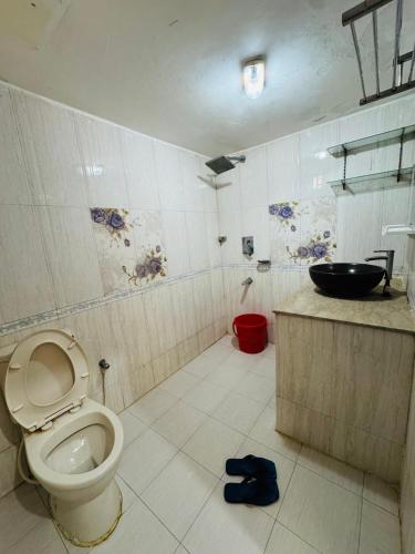 a bathroom with a toilet and a sink at Hotel Impulse Ocean View in Cox's Bazar