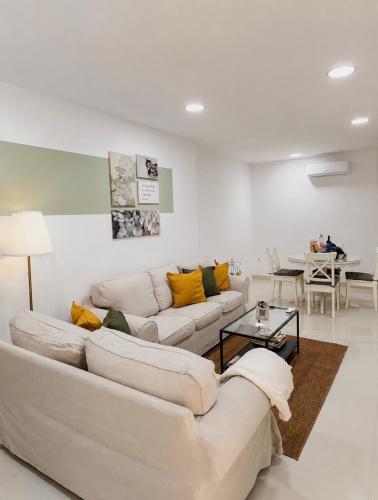a living room with two white couches and a table at Despertar in Antequera