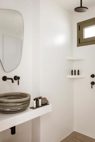 a bathroom with a sink and a mirror on a shelf at Halo Tinos - PHOEBUS in Tinos