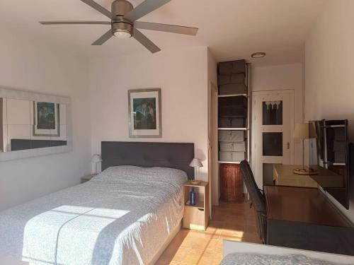 a bedroom with a bed and a ceiling fan at Casa Cármenes del Mar in Almuñécar