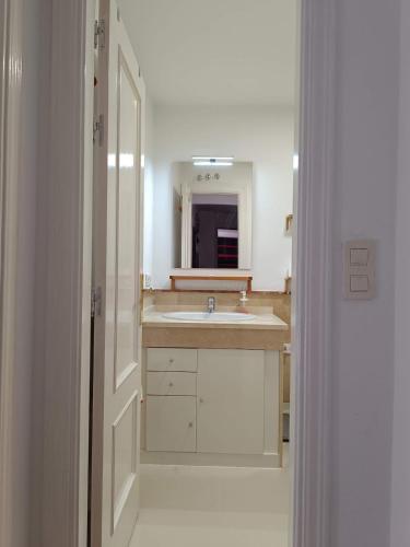 a bathroom with a sink and a mirror at Casa Cármenes del Mar in Almuñécar