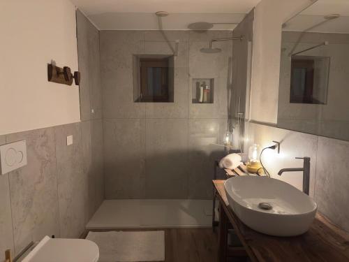 a bathroom with a sink and a tub and a toilet at Maison BelleVue in Châtillon