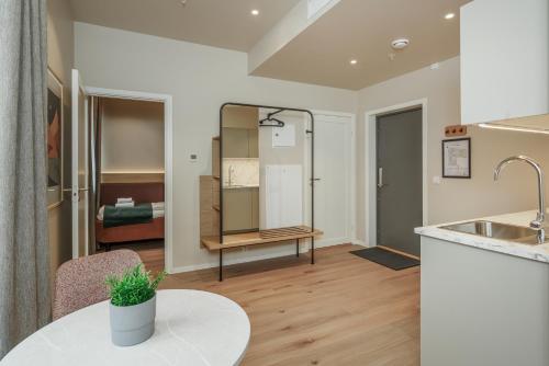 a living room with a sink and a table at MAYA Apartments - Vika in Oslo