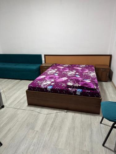 a bedroom with a bed and a couch at Зона отдыха Мирас in Kapchagay