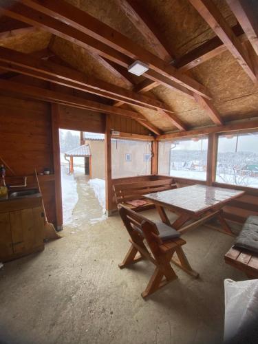 a room with a table and a chair in a house at BiSER PANČIĆA in Sekulić 