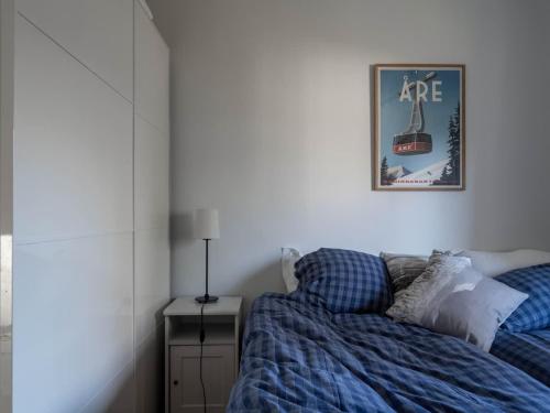 a bedroom with a bed and a picture on the wall at 2-Story Condo with Terrace in Åre
