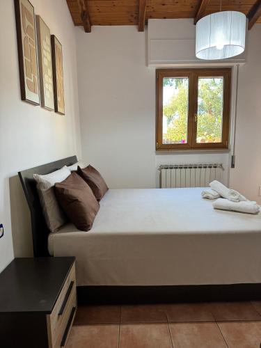 a bedroom with a large bed and a couch at Mespilia - Tra Mare e Città in Latina