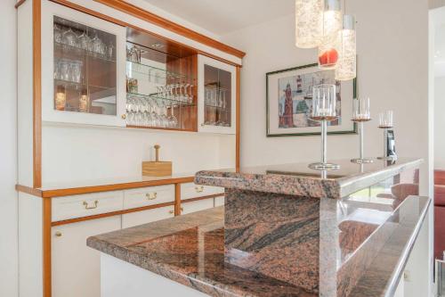 a kitchen with a counter with glasses on it at Ferienhaus Sonnendeck in Ueckeritz