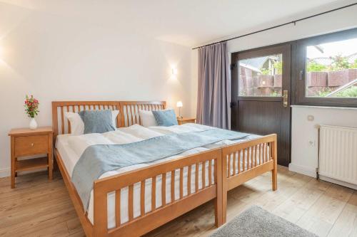 a bedroom with a large bed and a window at Ferienhaus Sonnendeck in Ueckeritz