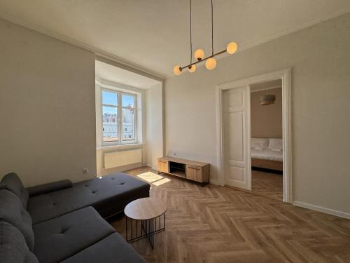 a living room with a couch and a table at Apartamenty Rynek 7 in Cieszyn