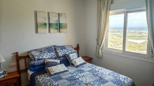 a bedroom with a bed and a window at Casa Las Vistas in Bolnuevo