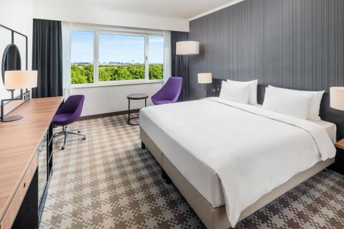 a hotel room with a large bed and a desk at Radisson Blu Hotel Amsterdam Airport, Schiphol in Schiphol