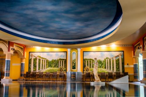 a room with paintings on the walls and a statue in the middle at Papuga Park Hotel Wellness Marrakesz & SPA in Bielsko-Biała