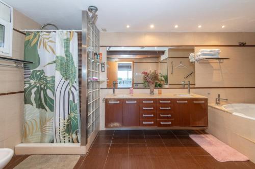 a bathroom with a sink and a tub and a shower at House close to the beach! Pool, ocean view! in Santa Susanna