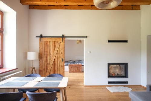 a living room with a wooden door and a fireplace at Pod Skalou in Temeš