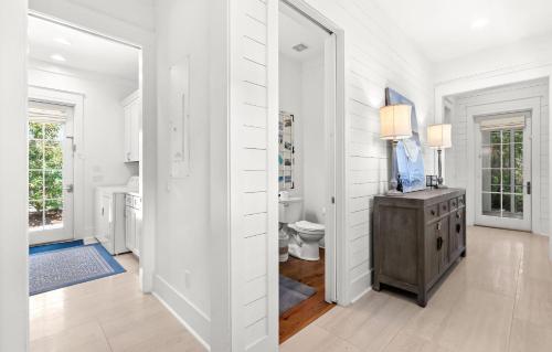 a white bathroom with a sink and a toilet at Southern Living Cottage in Santa Rosa Beach