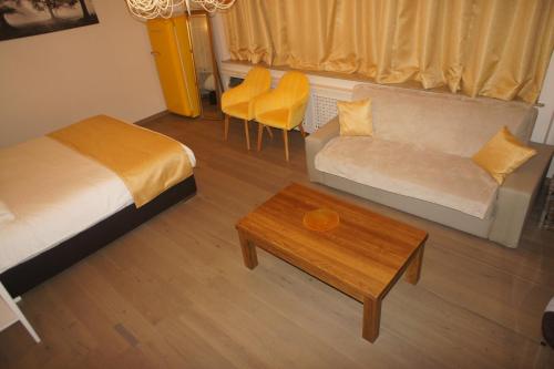 a room with a bed and a couch and a table at J and R Brussels City Apartment in Brussels