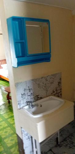 a bathroom with a sink and a mirror at Beachside Haven Homestay in Yarawa Island
