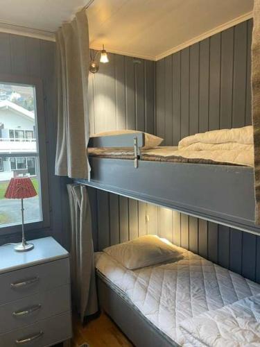 a bedroom with two bunk beds and a window at Central Apartment with Sauna & Balcony in Åre